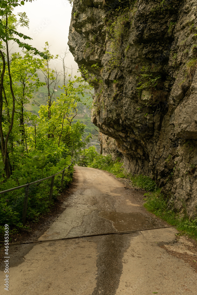 Appenzell, Switzerland, June 13, 2021 Small walkway below a rock in the alps