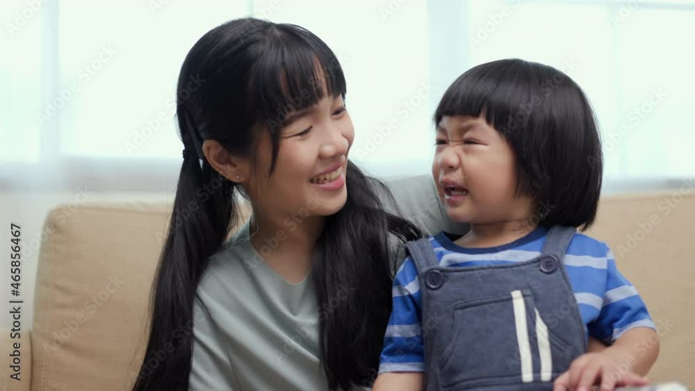Happy asian family mother and son reading book for education on sofa. Mom with kid read funny story book in relax moment time. Happy asian family mother and son reading book for education on sofa. Mom with kid read funny story book in relax moment time.