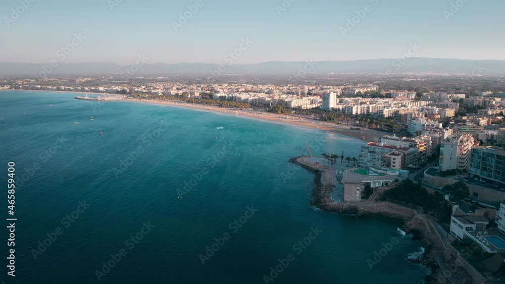 Beautiful aerial panorama of the Mediterranean coastal city of Salou in Spain. Top view from the sea with its turquoise waves to the beach, green alleys and building on the shore. Beautiful aerial panorama of the Mediterranean coastal city of Salou in Spain. Top view from the sea with its turquoise waves to the beach, green alleys and building on the shore.