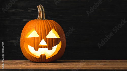 Halloween Pumpkin. Carved Pumpkin. Jack o lantern on Halloween. Large pumpkin on natural wooden background. Copy space for your text. Concept for Celebration Happy Halloween. Autumn season. 
