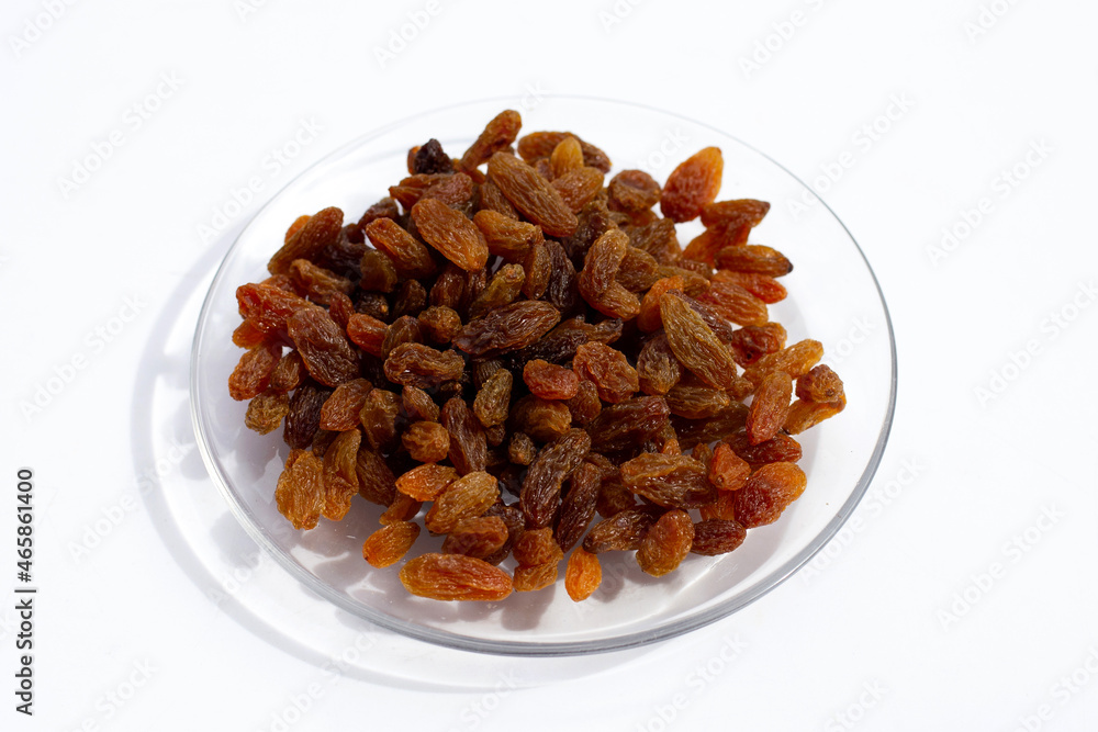 Dried grape raisins in glass plate on white background Dried grape raisins in glass plate on white background