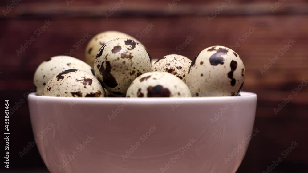 Quail Eggs On A White Plate On A Wooden Background. Dolly Slider Shot. Close Up. Quail Eggs On A White Plate On A Wooden Background. Dolly Slider Shot. Close Up.
