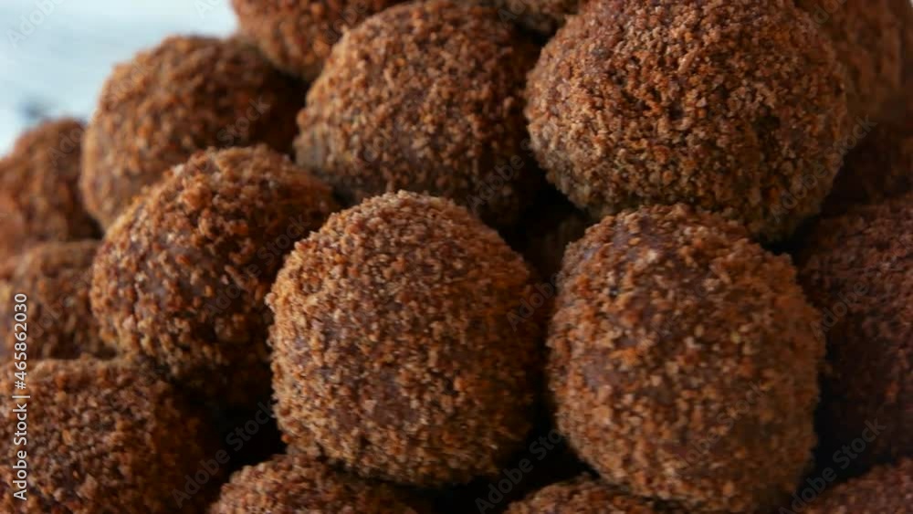 candies coated in chocolate cocoa and biscuit sweet brown balls close up