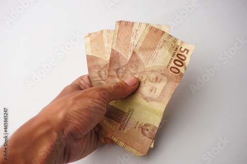 man hand showing rupiah Indonesian money