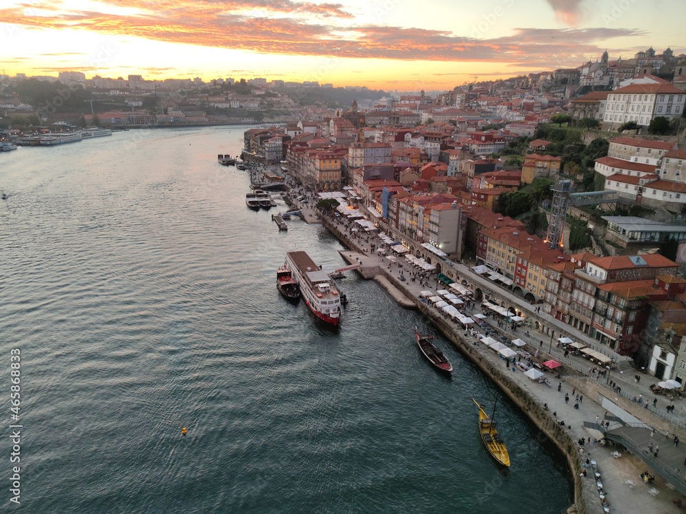 View over old town skyline and port, harbor at sunset on the Douro river at Porto, Portugal 
