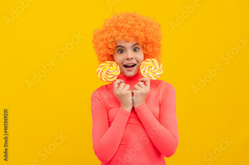 OMG. Surprised child hold lollipops. Lollipop fun. Childhood and girlhood. Try taste of sweet life