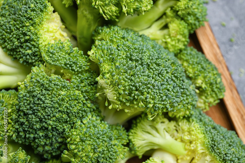 Board with healthy broccoli cabbage on color background, closeup