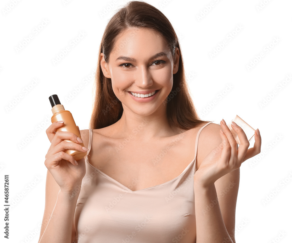 Happy woman holding spray bottle with essential oil on white background Happy woman holding spray bottle with essential oil on white background