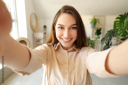 Happy woman taking selfie a...