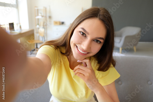 Young smiling woman taking ...