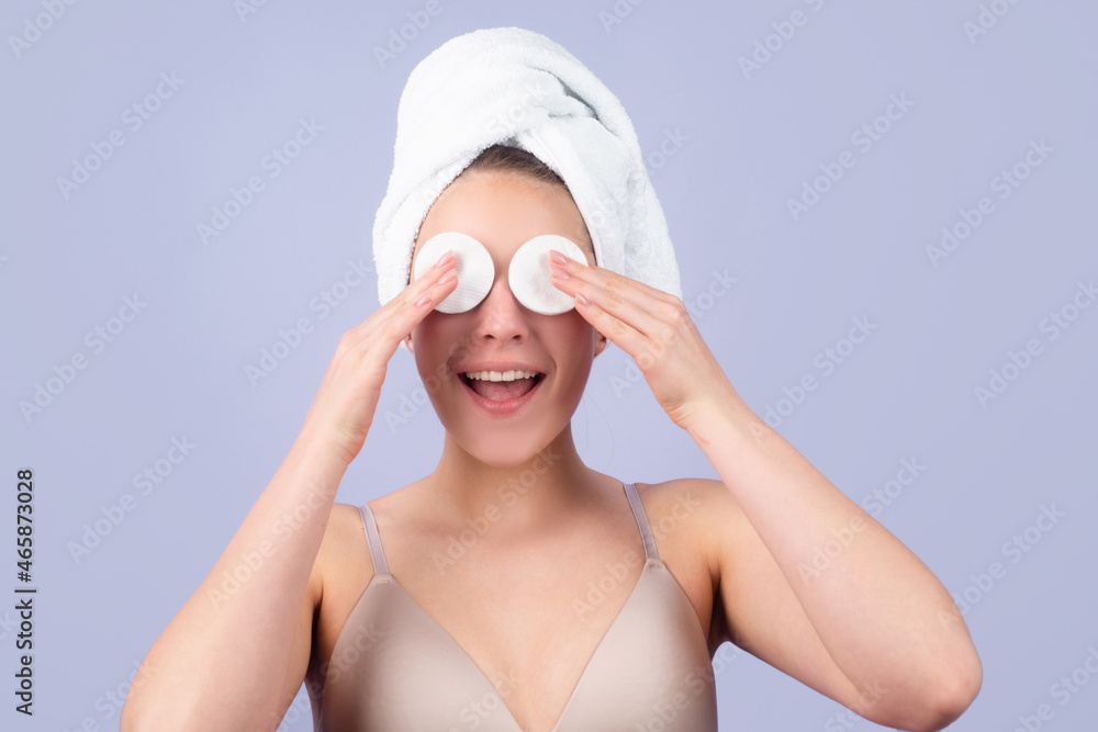 Funny beautiful girl with clean fresh skin. Facial treatment. Cosmetology beauty and spa. Girl apply skincare cream on face, woman wrap towel on head put facial creme on doing morning healthy skin. Funny beautiful girl with clean fresh skin. Facial treatment. Cosmetology beauty and spa. Girl apply skincare cream on face, woman wrap towel on head put facial creme on doing morning healthy skin.