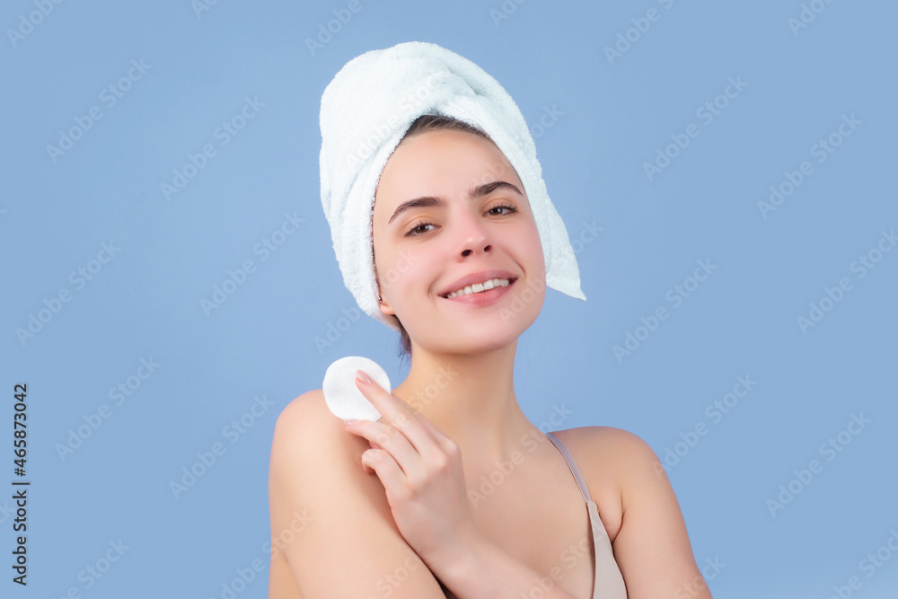 Cosmetic cream on woman face with clean soft skin. Body care. Woman with towel applying cream on skin. Body care and spa salon concept. Spa girl. Beautiful young woman with perfect skin. Cosmetic cream on woman face with clean soft skin. Body care. Woman with towel applying cream on skin. Body care and spa salon concept. Spa girl. Beautiful young woman with perfect skin.