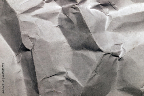 Contrasting grey crumpled paper with textured folds close-up