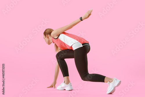 Sporty female runner on col...