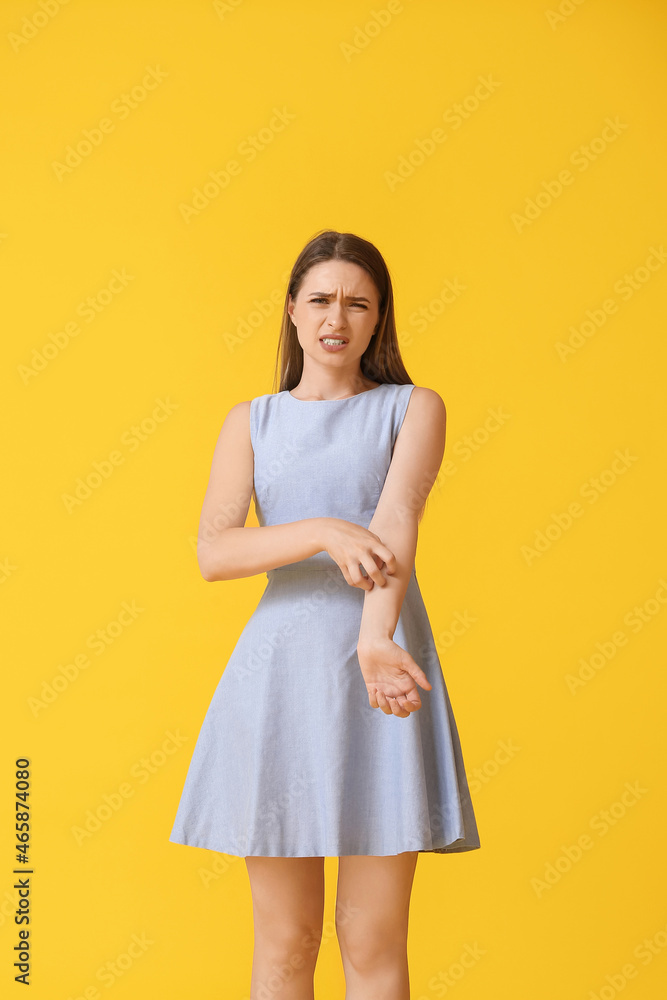 Young woman scratching herself on color background Young woman scratching herself on color background
