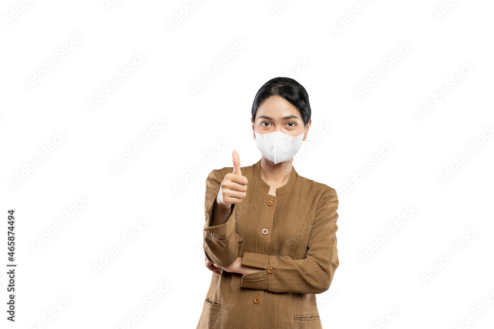 Indonesian women in civil servant uniforms wearing masks thumb up Indonesian women in civil servant uniforms wearing masks thumb up