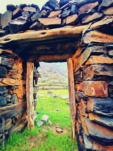 Cuadro en lienzo Old traditional stone house window with a view of green mountain