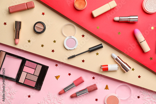 Makeup cosmetics with Christmas decor on color background