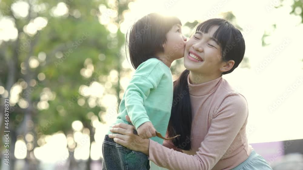 Happy asian family mother and kid spending time together at the park. Son and mom have fun enjoy family time at weekend with beautiful sun light. Lifestyle moments. Childhood and weekend concept Happy asian family mother and kid spending time together at the park. Son and mom have fun enjoy family time at weekend with beautiful sun light. Lifestyle moments. Childhood and weekend concept
