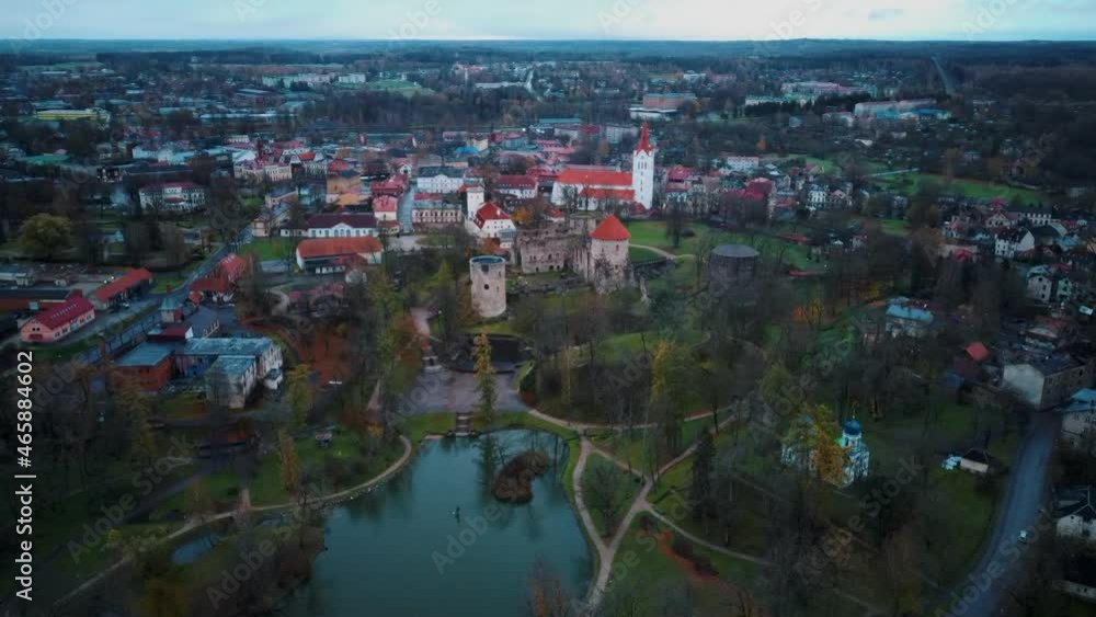 Panoramic Cesis City, Latvia Aerial View With Medieval St. John’s Church and Ruins of the Beautiful Castle a Residence of the Livonian Order in the Middle Ages. Autumn Evening Landscape at Sunset. Panoramic Cesis City, Latvia Aerial View With Medieval St. John’s Church and Ruins of the Beautiful Castle a Residence of the Livonian Order in the Middle Ages. Autumn Evening Landscape at Sunset.