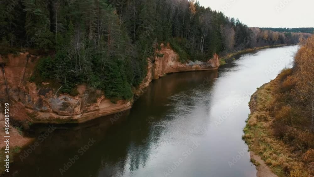Erglu Cliffs and Great View on the Gauja River Cesis, Latvia. Autumn Landscape Red Rocks Stone Cliff and River at Gauja National Park. Captured From Above With a Drone. Aerial Shot 4K. Erglu Cliffs and Great View on the Gauja River Cesis, Latvia. Autumn Landscape Red Rocks Stone Cliff and River at Gauja National Park. Captured From Above With a Drone. Aerial Shot 4K.