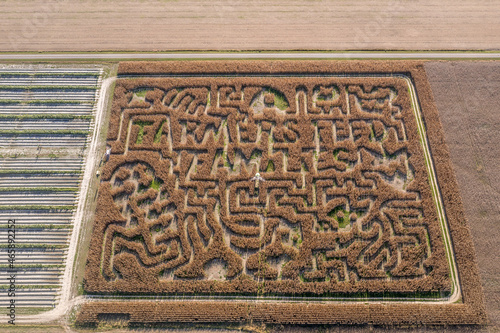 Aerial view of a Maryland corn maze labyrinth an American fall tradition before Halloween with farmers feed script photo