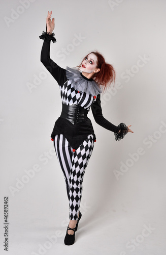  halloween, character, costume, figure pose, posing, portrait, gesture, isolated, magical, dynamic movement, isolated, studio background, red hair, circus, theatre, jester, clown, full length,