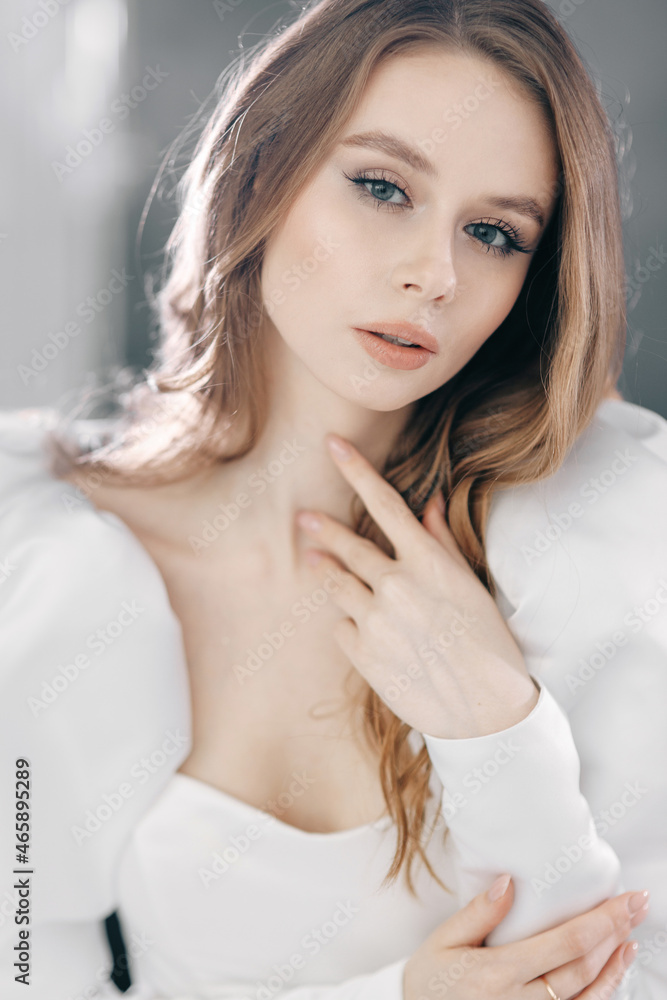 The bride's model poses in the studio, a photo shoot with smoke on a dark background. A beautiful bride in a modern short dress. The bride's model poses in the studio, a photo shoot with smoke on a dark background. A beautiful bride in a modern short dress.