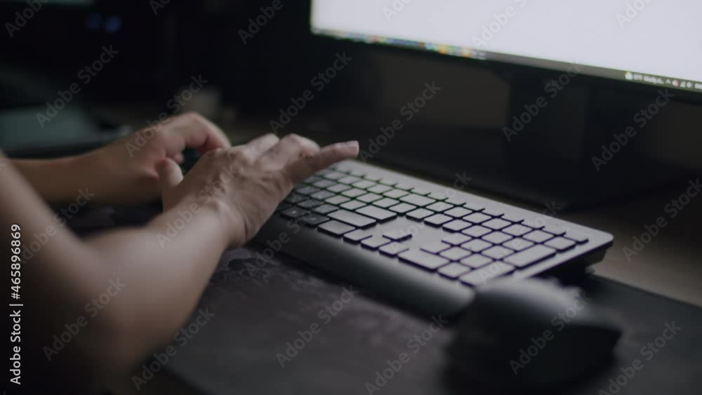 Close-Up hand typing keyboard of businesswoman staying late hours in the home office concentrating on her work sitting with a computer. Close-Up hand typing keyboard of businesswoman staying late hours in the home office concentrating on her work sitting with a computer.