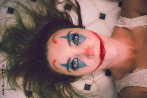 portrait of a woman with clown makeup on joker Halloween 