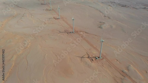 Aerial zoom in shot of a row of windmills in Red Sea desert, Egypt photo