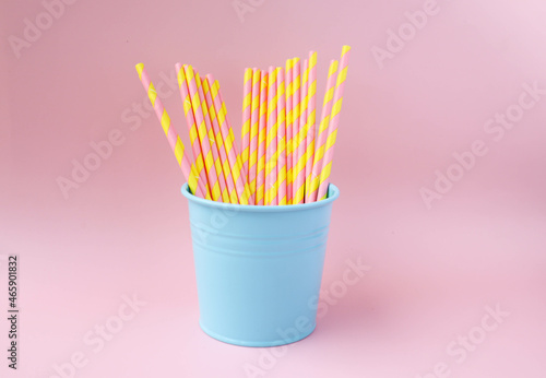 Paper drinking straw in pastel color in pink background - party  birthday and cute concept