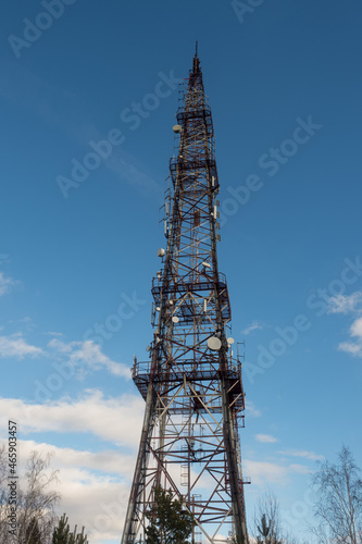 communication tower on the background of the sky with clouds