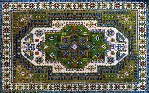 The texture of the Persian carpet, abstract ornament. Oval Mandala Pattern, Traditional Middle Eastern Carpet Fabric Texture. Turquoise milky green beige, light green, brown. vintage, oriental motifs