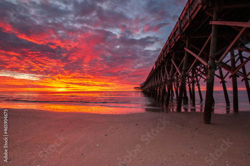 fiery sunrise at the beach pier