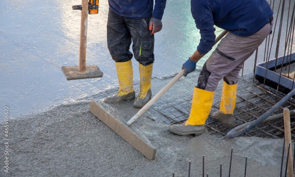 Concreting a base plate with ready-mixed concrete on the construction site of a residential building Concreting a base plate with ready-mixed concrete on the construction site of a residential building