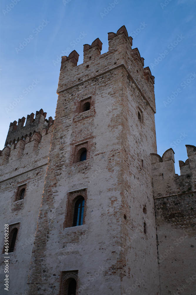 Sirmione Castle, Italy. Close-up of an ancient castle in Italy. Historic castle wall on the water. Fortress on the water. Castle tower.