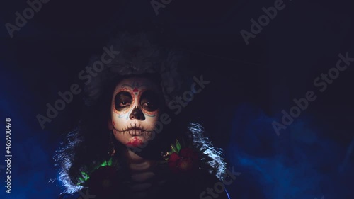 Woman with mexican skull halloween makeup on face. Day of the dead aka Dia de los Muertos
