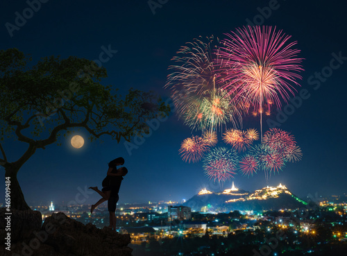 Lovers couple background night city, starry sky fireworks. Concept date Valentine Day, first kiss.