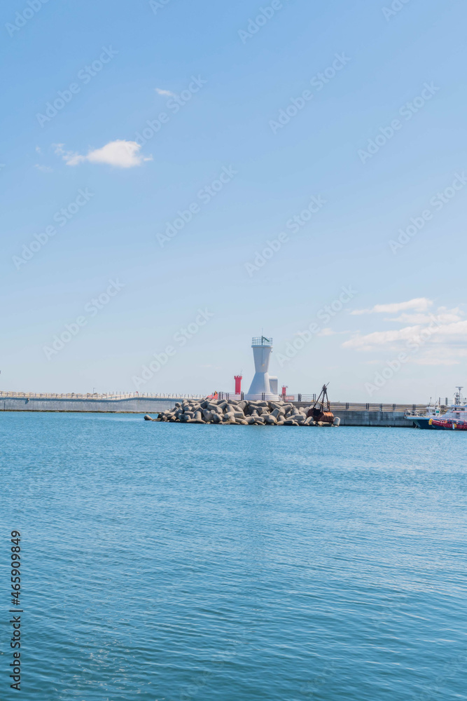 Seascape of Korean harbor with white lighthouse