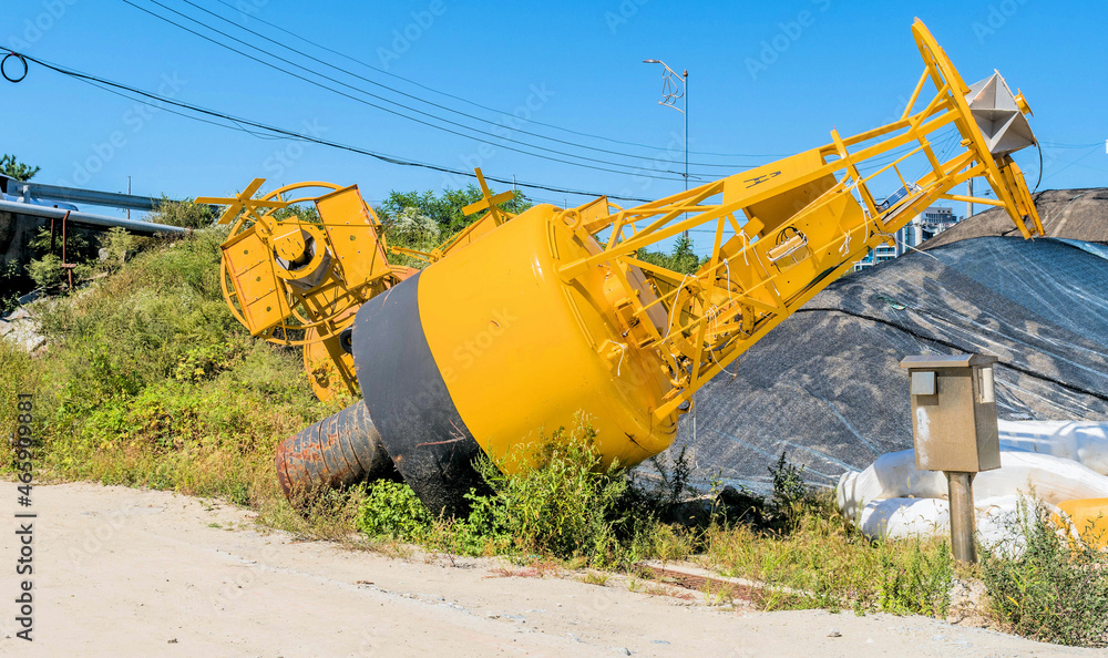 Large yellow buoy laying on hillside Large yellow buoy laying on hillside