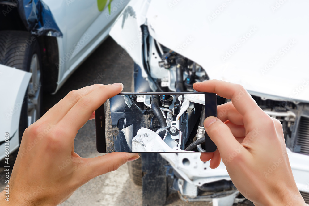 Man photographing his vehicle with damages for accident insurance with smart phone