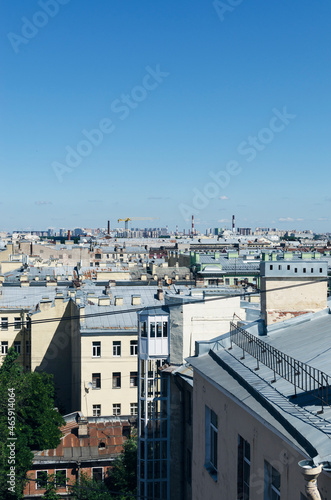 RUSSIA, Saint Petersburg: Scenic aerial cityscape view of the sunny city roofs and architecture with blue clear sky