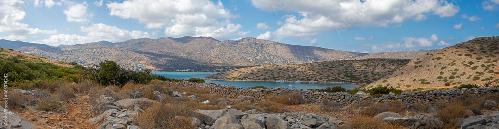 beautiful panoramic view of the mountains with clouds from the bay near the sunken city of Olus, on the island of crete on a sunny day, horizontal