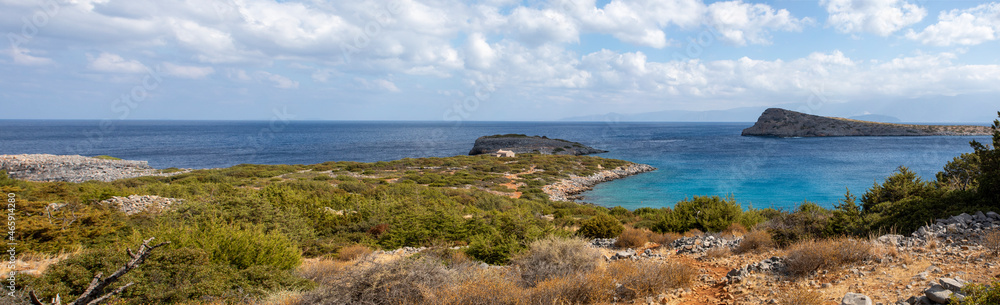 beautiful panoramic view of the mountains with clouds from the bay near the sunken city of Olus, on the island of crete on a sunny day,