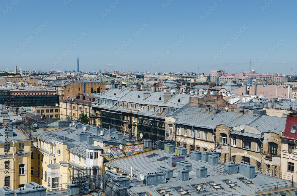 Fototapeta premium RUSSIA, Saint Petersburg: Scenic aerial cityscape view of the sunny city roofs and architecture with blue clear sky