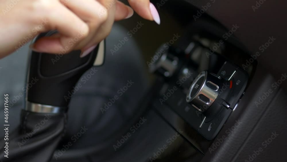 a woman's hand adjusts the air conditioner setting in the car a woman's hand adjusts the air conditioner setting in the car