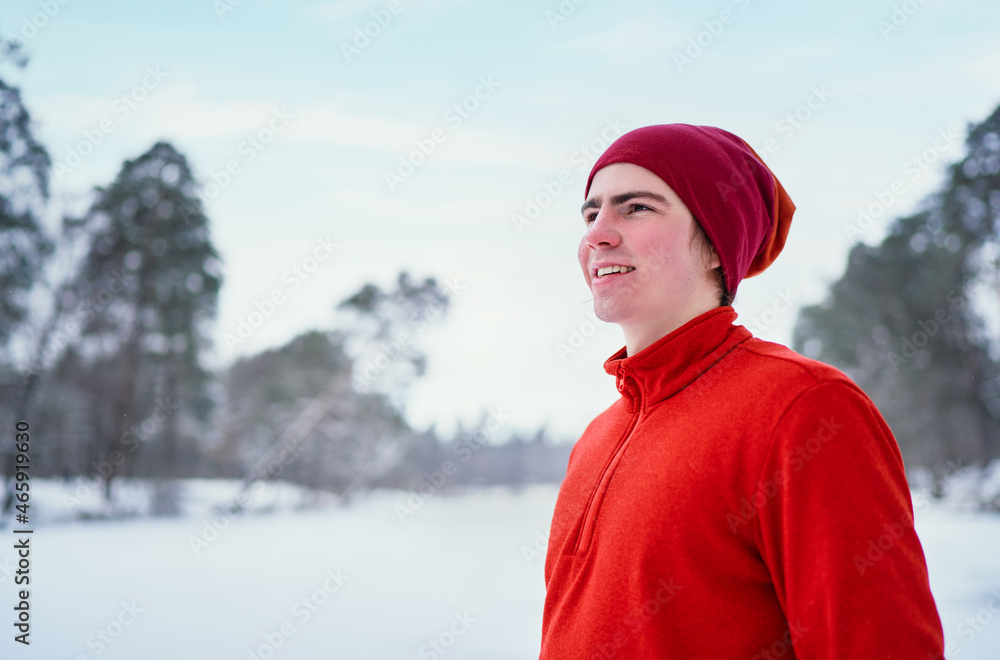 Winter sports. Happy young man relaxing after sport activity at snowy park. Winter sports. Happy young man relaxing after sport activity at snowy park.