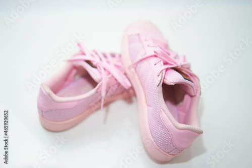 pink sneakers shoes with shoelace top angle view on floor soft focus