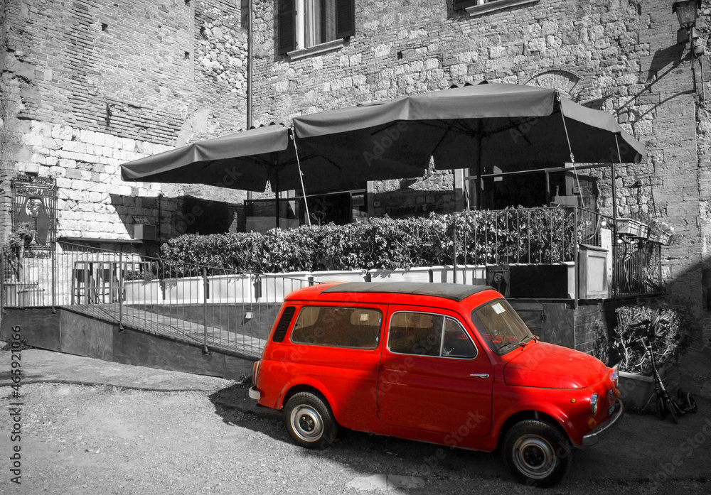 Fototapeta premium old red car in the street of Montepulciano